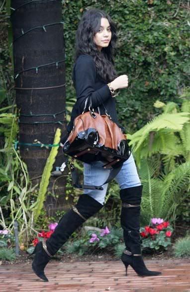 She also wears a black knee-high boots partnered with sweater and jeans.